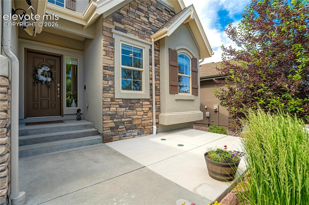 Image 3 of 48: A welcoming covered entry sets the tone for the warmth, comfort + thoughtfu
