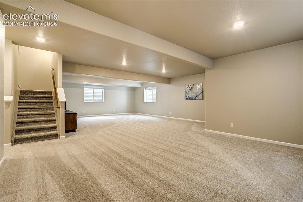 Image 33 of 48: The expansive lower-level recreation room offers exceptional flexibility fo