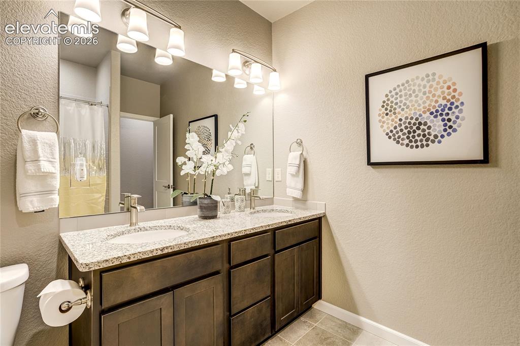 Image 40 of 48: A full lower-level bath comfortably serves guests and secondary bedrooms.