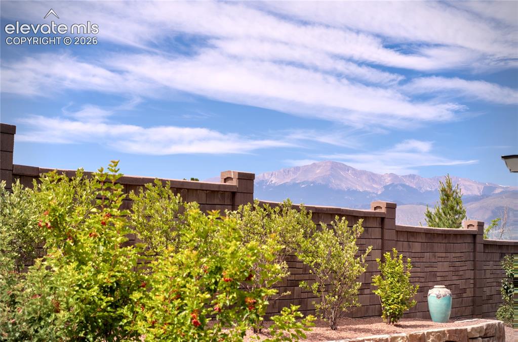 Image 46 of 48: Mountain Views, Terraced retaining walls and mature landscaping create a pr