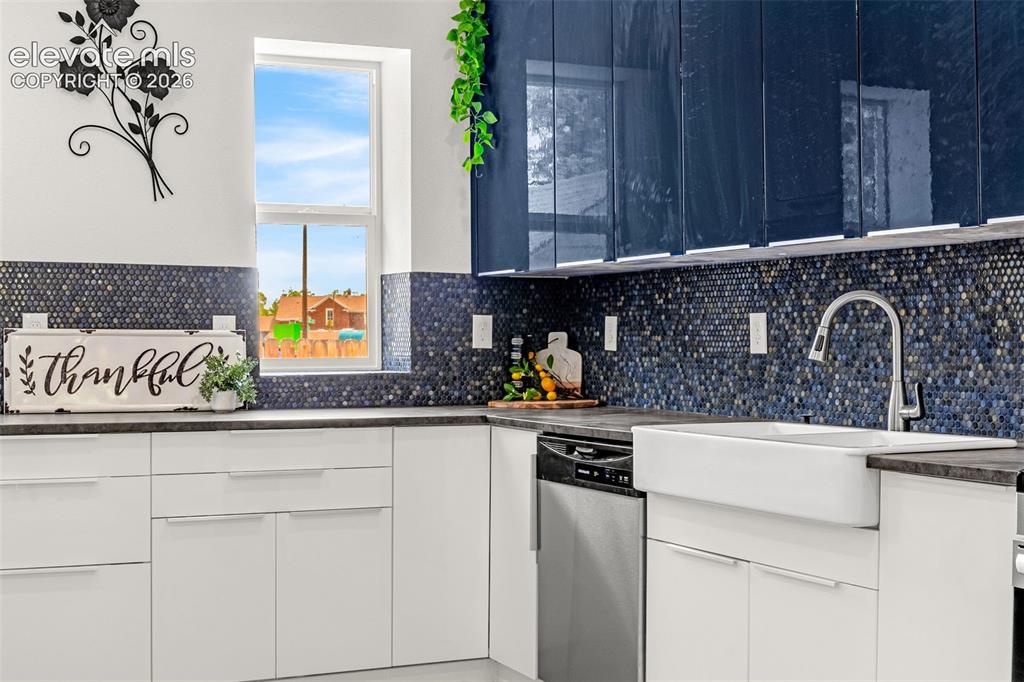 Image 31 of 50: Modern kitchen featuring a white farmhouse sink, stainless steel dishwasher