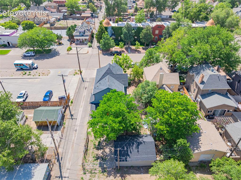 Image 45 of 50: Aerial perspective showcasing a residential property with a dark shingle ro