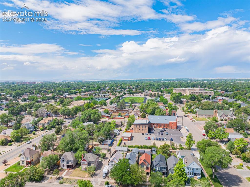 Image 46 of 50: Aerial perspective showcasing a residential area with mature tree canopies,