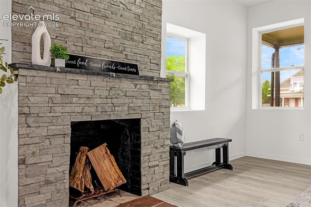 Image 9 of 50: Stone-clad fireplace with a dark mantel, featuring a firebox and hearth