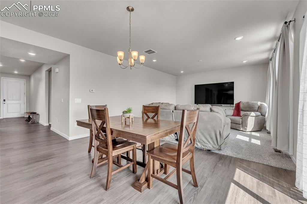 Image 10 of 50: Dining space featuring light wood-type flooring, recessed lighting, and a c