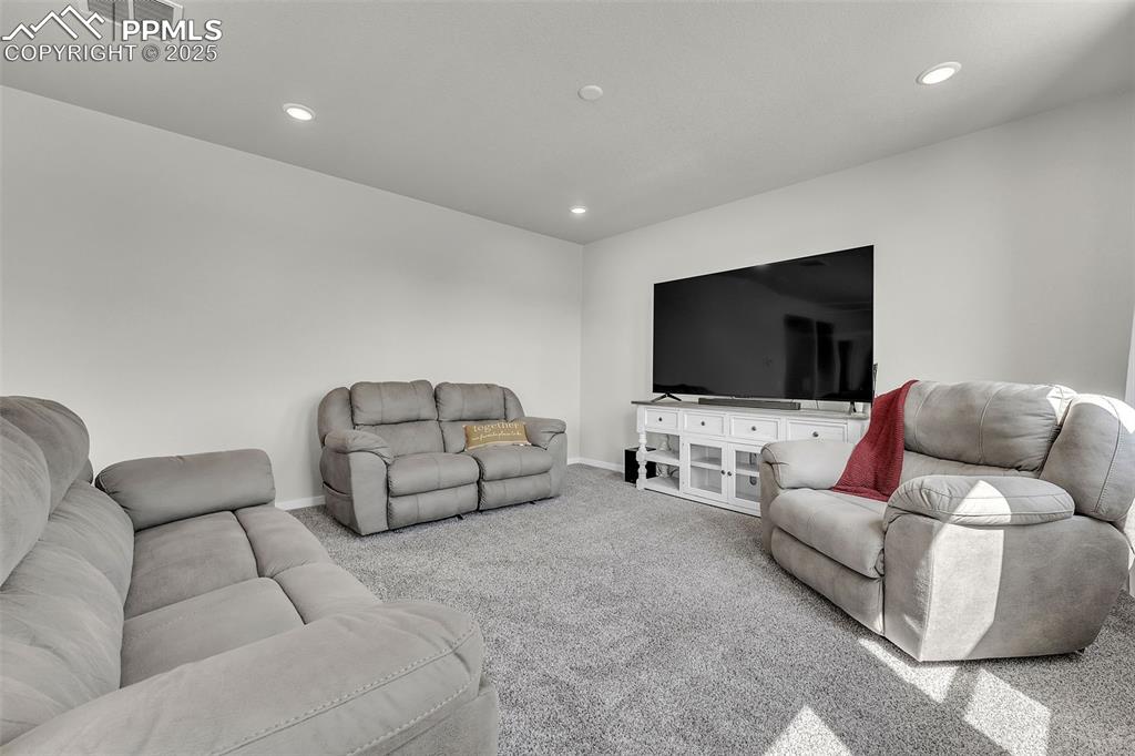 Image 11 of 50: Living room featuring carpet and recessed lighting