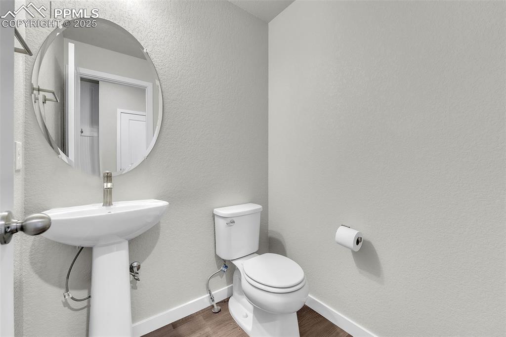 Image 15 of 50: Bathroom featuring a textured wall and wood finished floors
