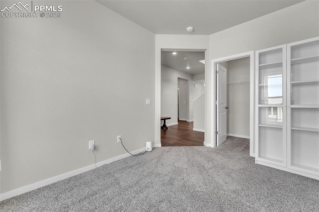 Image 17 of 50: Unfurnished bedroom featuring carpet floors and a spacious closet