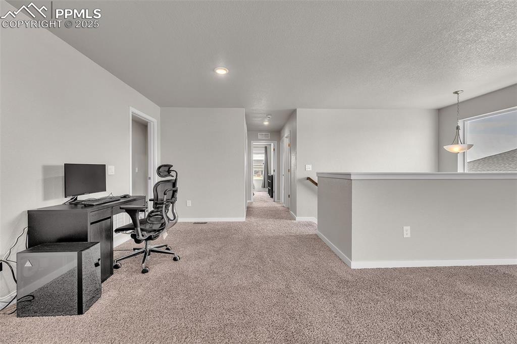 Image 22 of 50: Office with light colored carpet and baseboards