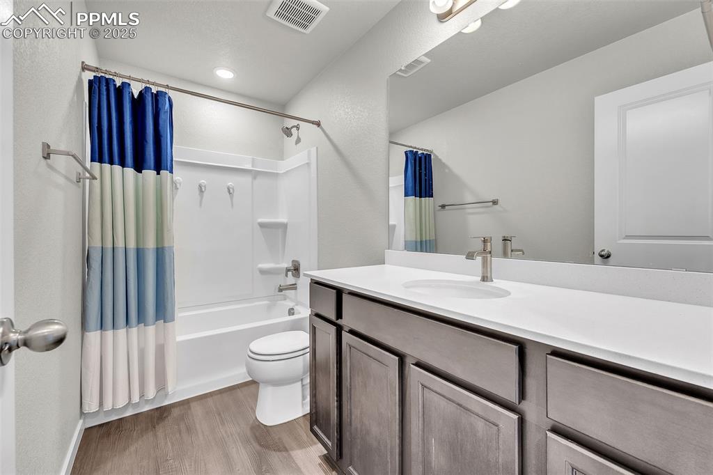 Image 24 of 50: Full bath with shower / bath combination with curtain, vanity, and light wo