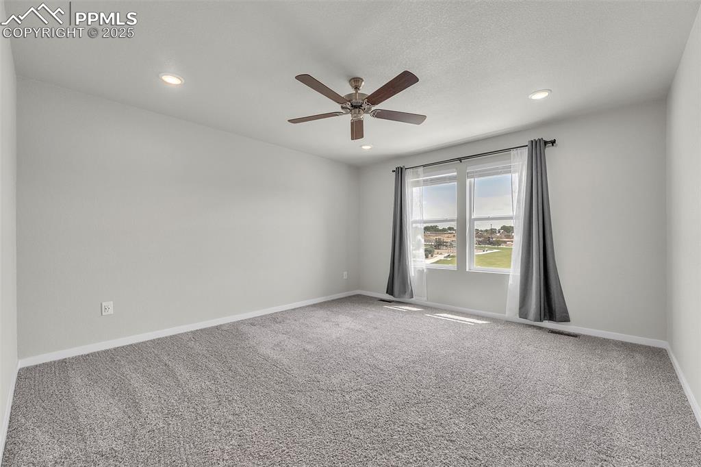 Image 34 of 50: Carpeted spare room featuring a ceiling fan and recessed lighting