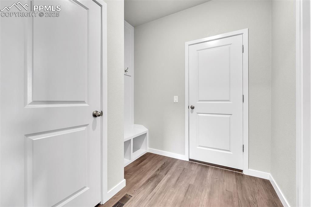 Image 4 of 50: Mudroom with baseboards and light wood-style floors