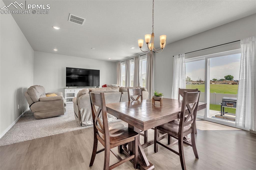 Image 9 of 50: Dining area with healthy amount of natural light, light wood-style flooring