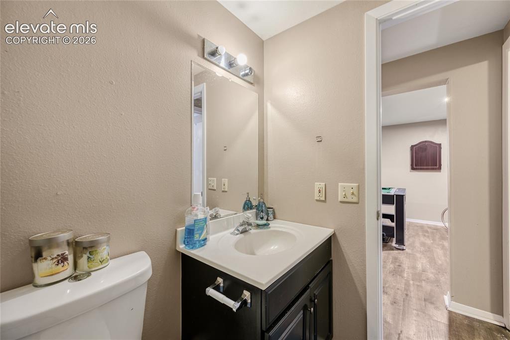 Image 16 of 49: Vanity with an integrated sink and chrome faucet, set against neutral wall 