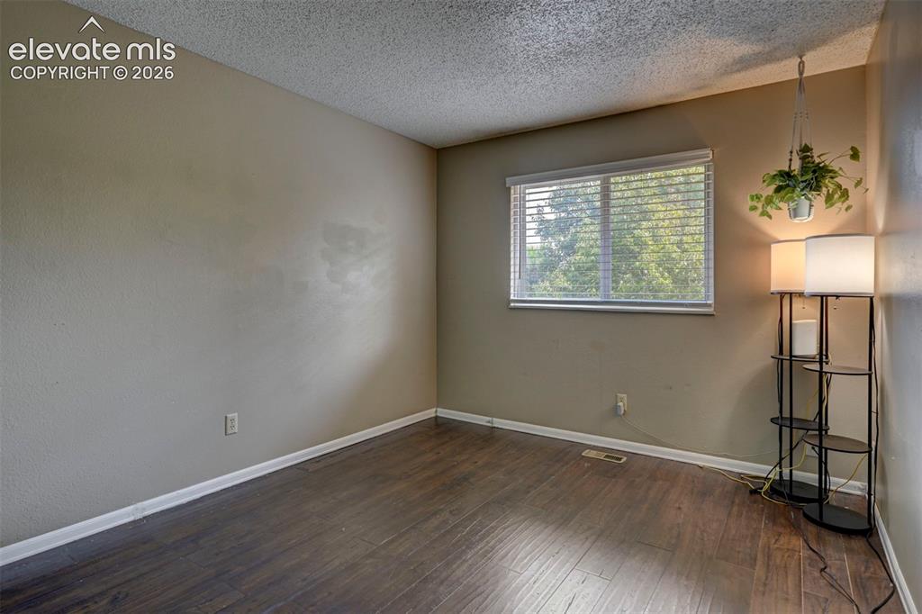 Image 32 of 49: Wood-finish flooring with neutral wall tones and a window with horizontal b