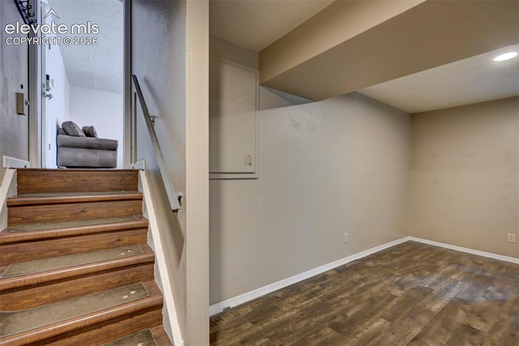 Image 36 of 49: Wood-finish flooring with recessed lighting