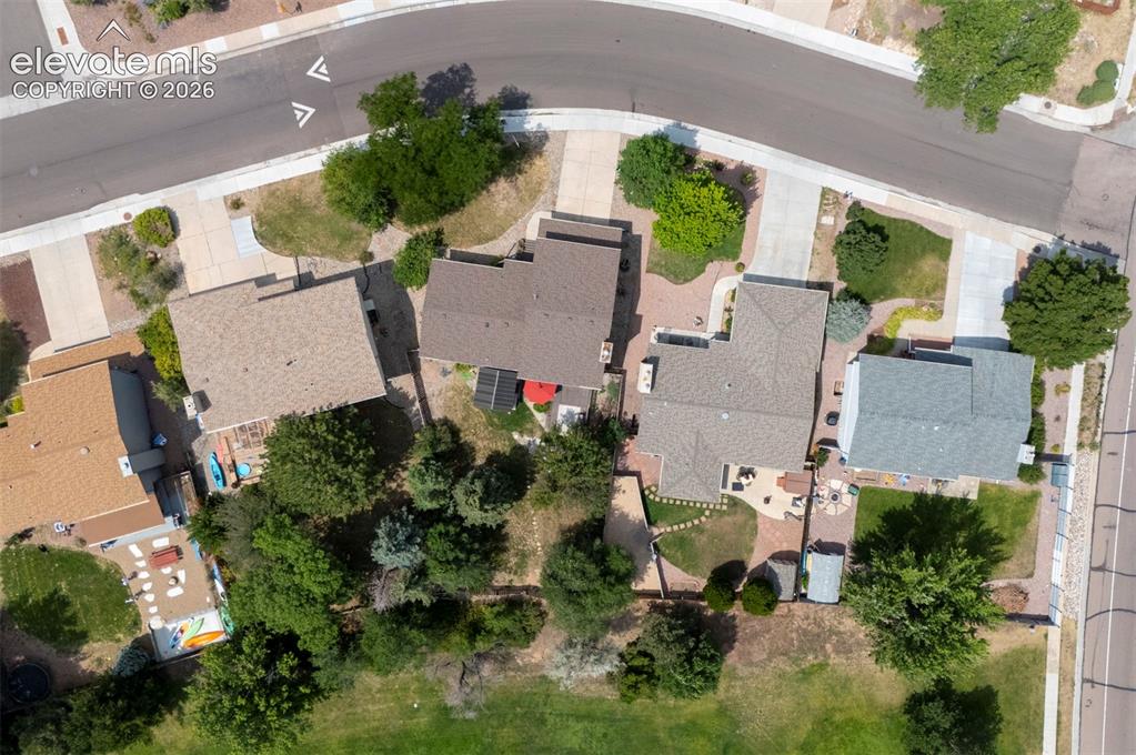 Image 8 of 49: Residential neighborhood setting with concrete roadways, sidewalks, and est