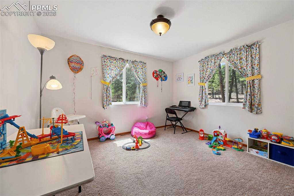 Image 14 of 25: Bright room featuring neutral carpet flooring, white walls, two windows wit