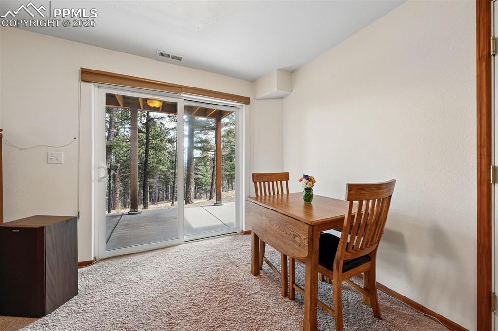 Image 17 of 25: Sliding glass door leading to an outdoor concrete patio