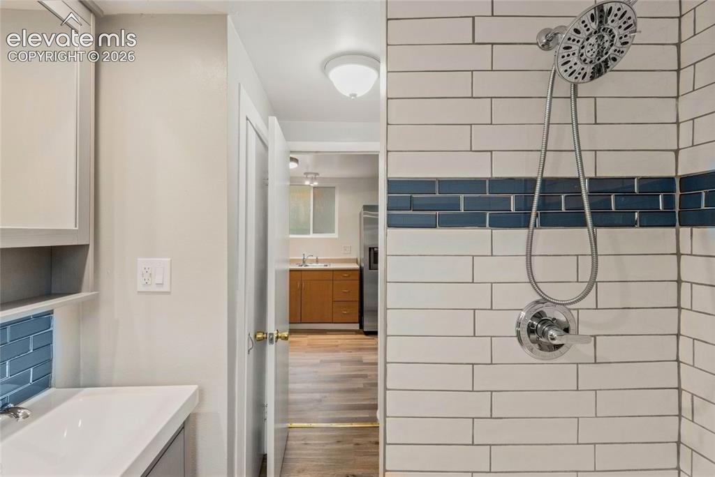 Image 29 of 41: Bathroom with stand-up shower and subway tile