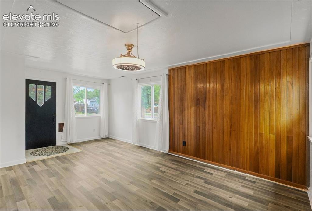 Image 5 of 41: Entry with real wood paneling and plenty of light