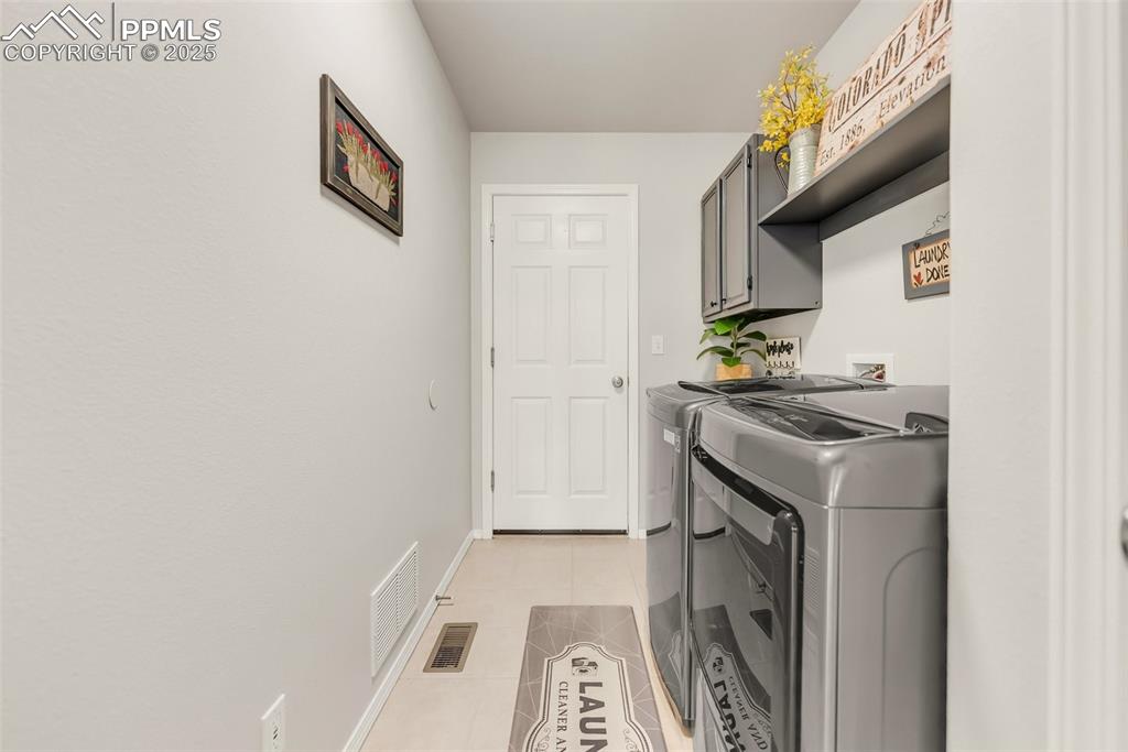 Image 17 of 47: Nice laundry space off garage with great storage