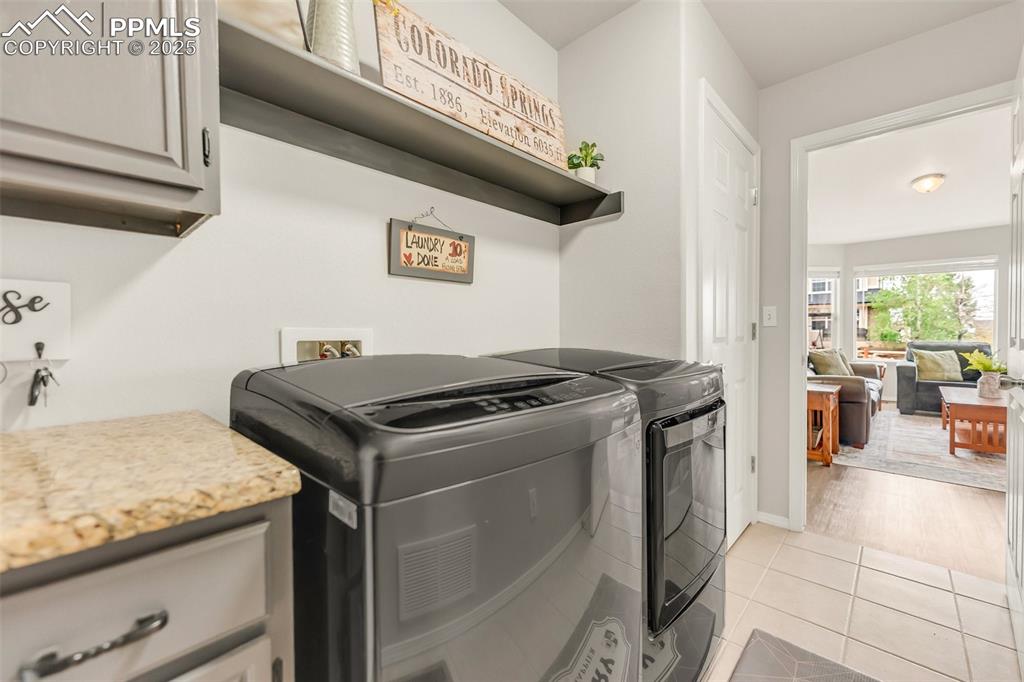Image 18 of 47: Nice laundry space off garage with great storage