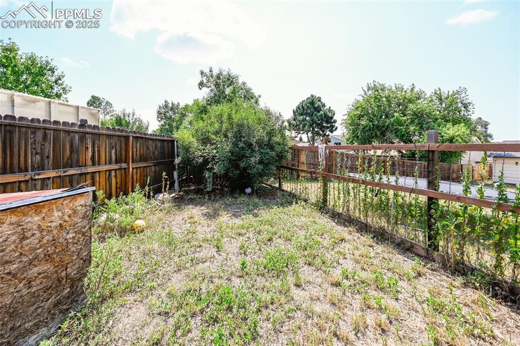 Image 17 of 19: View of fenced backyard
