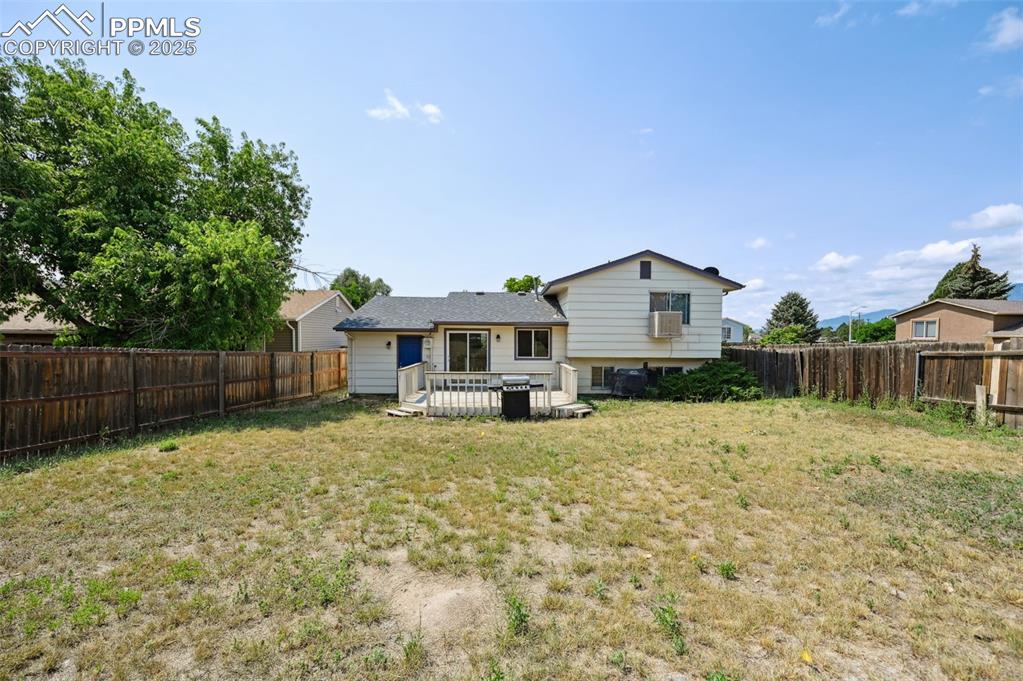 Image 18 of 19: Back of property featuring a fenced backyard