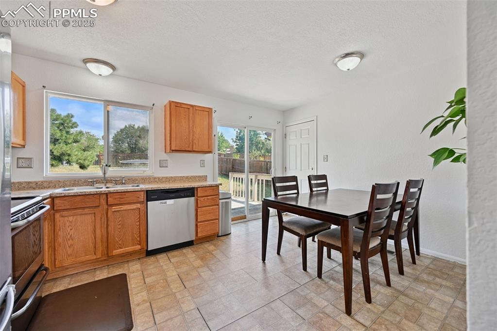 Image 5 of 19: Kitchen with appliances with stainless steel finishes, a textured ceiling, 