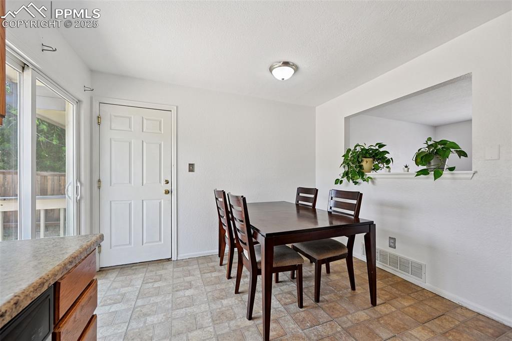 Image 6 of 19: Dining area featuring baseboards