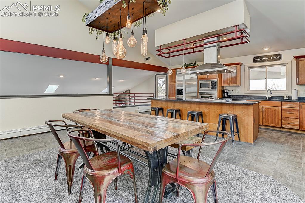 Image 17 of 42: Dining area with vaulted ceiling