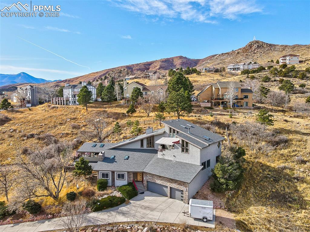 Image 2 of 42: Aerial view of property and surrounding area with a mountainous background