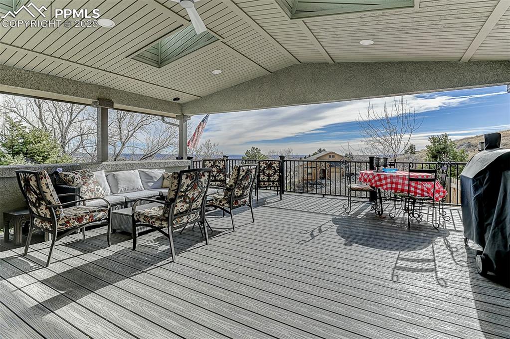 Image 21 of 42: Deck from kitchen with an outdoor hangout area, outdoor dining space, and g