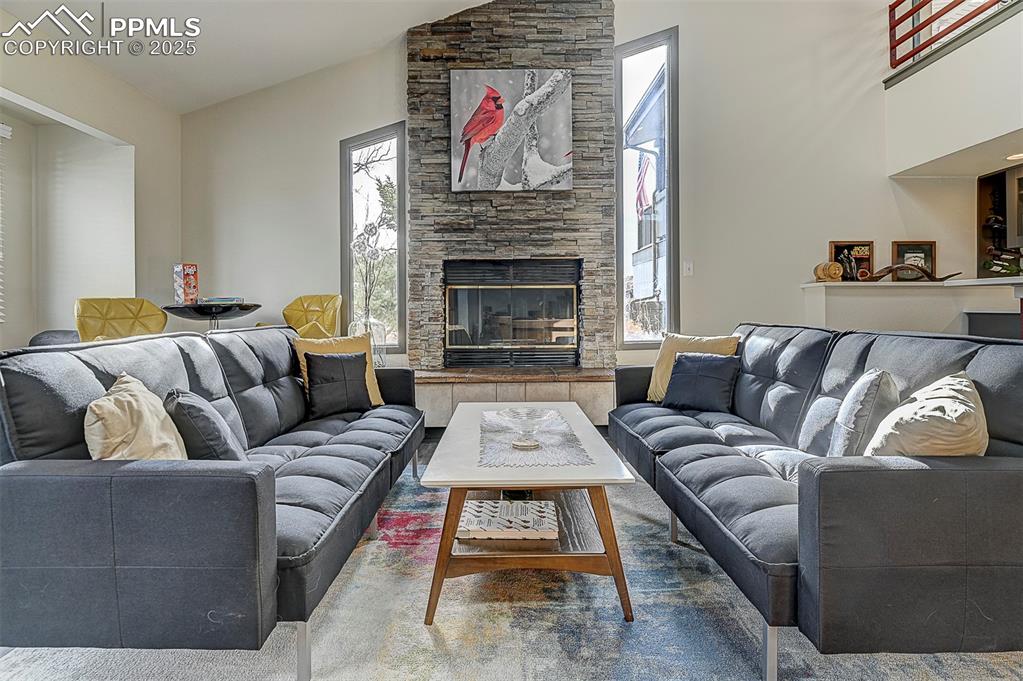 Image 4 of 42: Living area featuring a fireplace