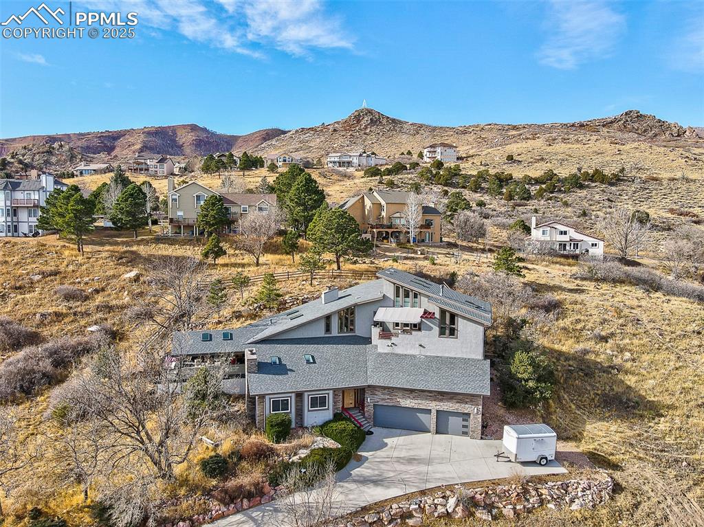 Image 42 of 42: Aerial view of property and surrounding area featuring a mountain backdrop