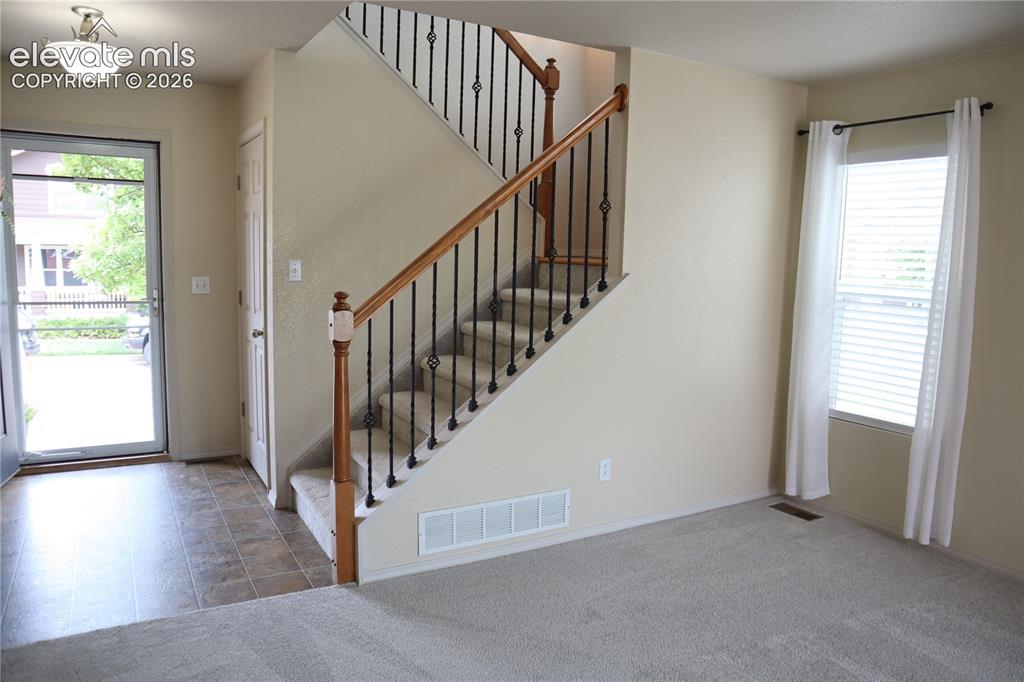 Image 12 of 34: Front Entry and Staircase.