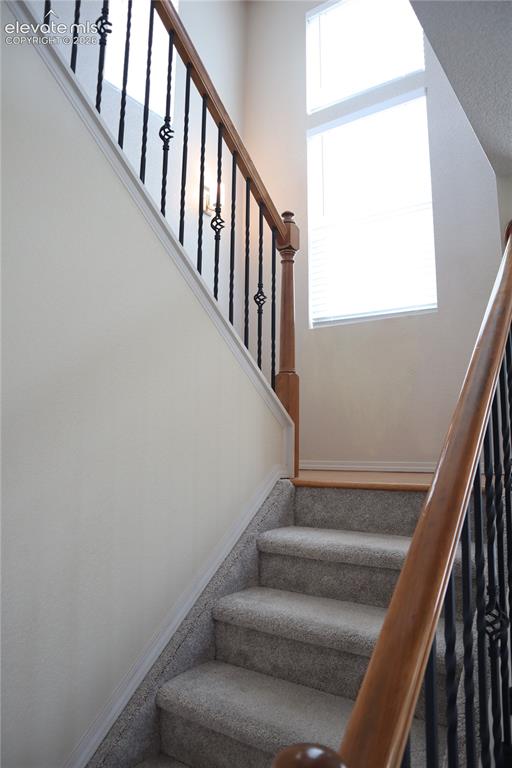 Image 13 of 34: Staircase with Wrought Iron Spindles.