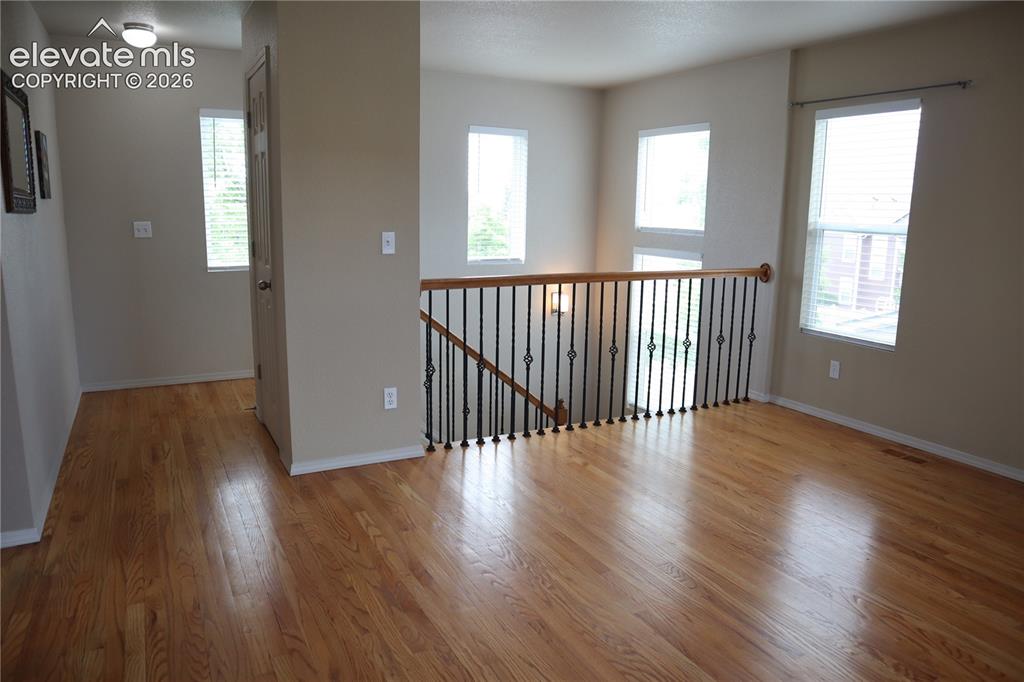 Image 19 of 34: Hardwood Floors and Mountain Views From Upstairs Family Room.