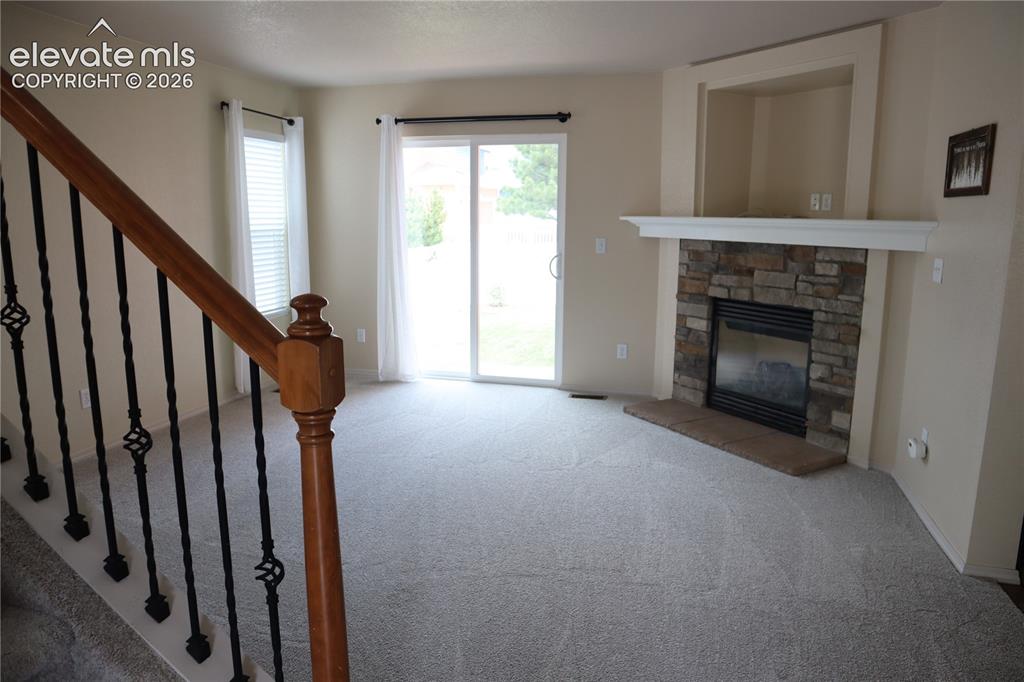 Image 3 of 34: Walk Out, Gas Fireplace and New Carpet.