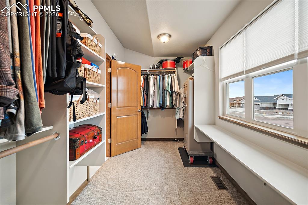 Image 18 of 49: Huge walk in closet with picture window and natural light.