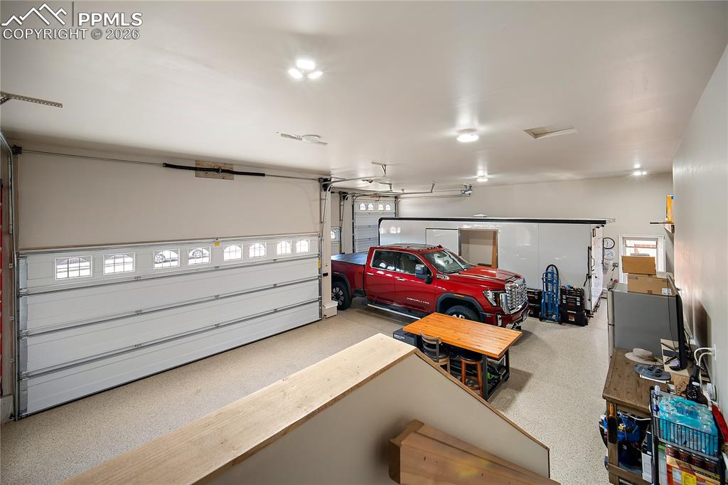 Image 34 of 49: Finished garage with RV parking. A car lovers dream!