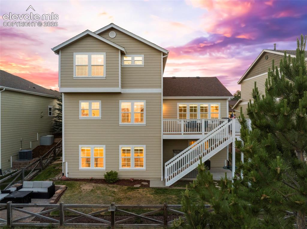 Image 2 of 41: Expansive deck and walk out basement backing to open space and a walking tr