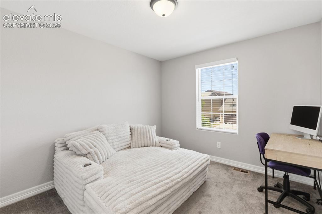 Image 27 of 41: One of two secondary upper level bedrooms