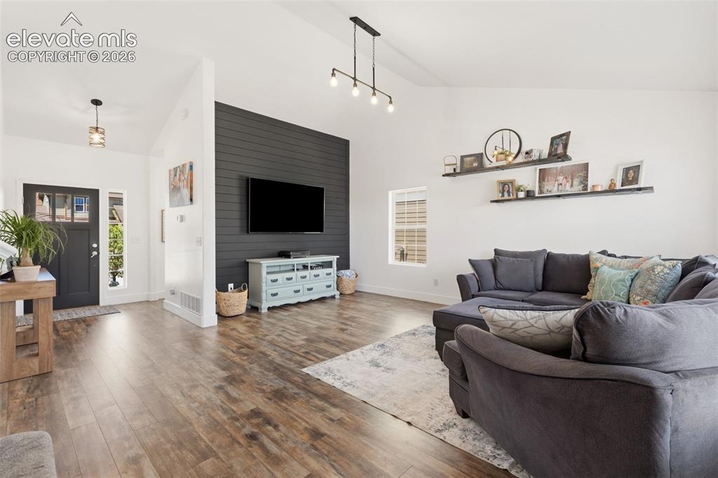 Image 7 of 41: Large living room with tons of light and vaulted ceilings