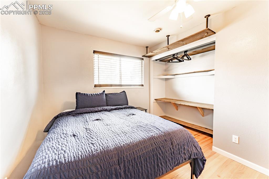 Image 16 of 39: Bedroom featuring light wood finished floors and ceiling fan