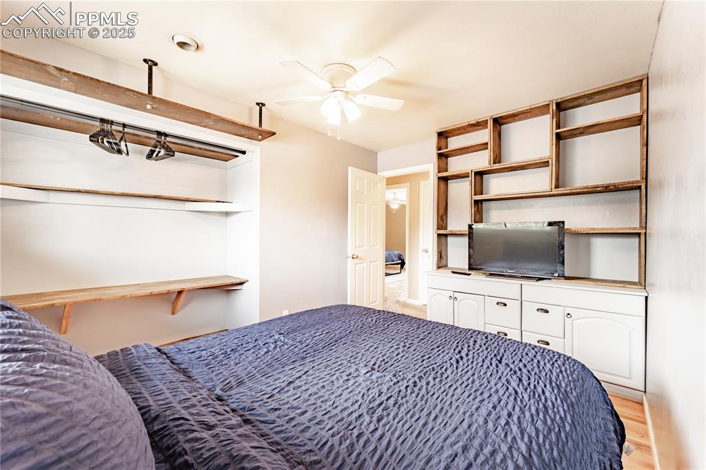 Image 17 of 39: Bedroom with a ceiling fan and light wood-style flooring