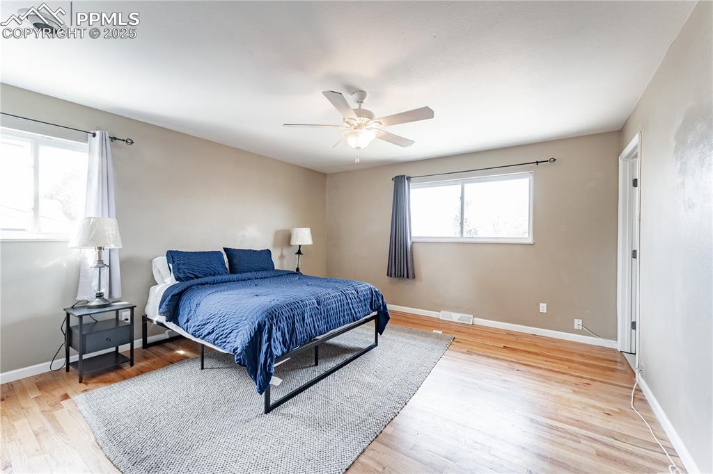 Image 20 of 39: Bedroom with light wood-style flooring and ceiling fan