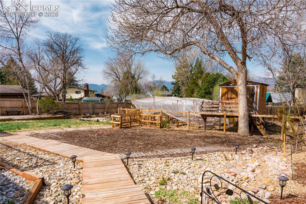 Image 3 of 39: Fenced backyard featuring an outdoor structure and exterior structure