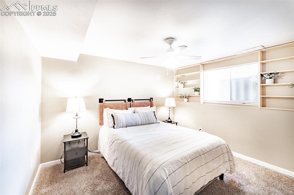 Image 31 of 39: Carpeted bedroom with ceiling fan and baseboards
